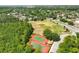 Aerial view featuring tennis courts and sports complex in lush, green community at 3534 Woodley Park Pl, Oviedo, FL 32765