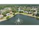 An aerial view of a community lake and landscaped properties in a neighborhood at 3534 Woodley Park Pl, Oviedo, FL 32765