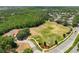 Aerial view showcasing community tennis courts, playground, and athletic field at 3534 Woodley Park Pl, Oviedo, FL 32765
