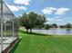 Backyard view featuring a large pond with water fountain and meticulous landscaping at 3534 Woodley Park Pl, Oviedo, FL 32765