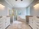 This bathroom features a walk in shower, soaking tub, and and vanities at 3534 Woodley Park Pl, Oviedo, FL 32765