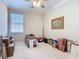 Neutral bedroom featuring a ceiling fan, window, and beige carpet at 3534 Woodley Park Pl, Oviedo, FL 32765