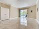 Open bonus room with tile floors, a sliding glass door to the pool, and ample space for entertaining guests at 3534 Woodley Park Pl, Oviedo, FL 32765
