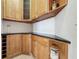 A kitchen with brown cabinets, granite countertops and a built-in wine rack at 3534 Woodley Park Pl, Oviedo, FL 32765