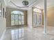 Spacious foyer with plantation shutters, decorative lighting, and marble floors offering an open and bright space at 3534 Woodley Park Pl, Oviedo, FL 32765