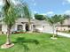 Charming single-story home with a well-manicured lawn, palm trees, and a welcoming front entrance at 3534 Woodley Park Pl, Oviedo, FL 32765