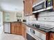 Gourmet kitchen features granite countertops, stainless steel appliances, and custom cabinets at 3534 Woodley Park Pl, Oviedo, FL 32765