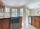 Kitchen featuring wine cooler, stainless steel dishwasher, granite countertops, and pool views at 3534 Woodley Park Pl, Oviedo, FL 32765