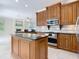Kitchen featuring custom wood cabinets, granite countertops, stainless appliances, and marble flooring at 3534 Woodley Park Pl, Oviedo, FL 32765