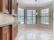 Kitchen breakfast nook with custom cabinetry, granite countertops, and views of the pool at 3534 Woodley Park Pl, Oviedo, FL 32765