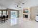 Open living area featuring a fireplace and views of the outdoor pool through sliding glass doors at 3534 Woodley Park Pl, Oviedo, FL 32765