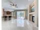 Open living area with fireplace, tile floors and sliding glass doors with views of the pool at 3534 Woodley Park Pl, Oviedo, FL 32765