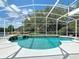Beautiful screened pool with water feature surrounded by lush landscaping at 3534 Woodley Park Pl, Oviedo, FL 32765