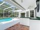 Covered patio with access to outdoor swimming pool and kitchen area at 3534 Woodley Park Pl, Oviedo, FL 32765