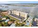 A sunny aerial view of a waterfront condo complex and surrounding neighborhood with scenic water views at 3606 S Peninsula Dr # 707, Port Orange, FL 32127