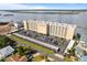 Aerial view showcases the entire building, parking facilities and surrounding landscape at 3606 S Peninsula Dr # 707, Port Orange, FL 32127