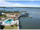 Aerial view showcases pool, waterfront, dock, and boat, under a clear blue sky at 3606 S Peninsula Dr # 707, Port Orange, FL 32127