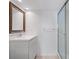 Bathroom featuring modern vanity, framed mirror, walk-in shower with glass doors, and tiled floor at 3606 S Peninsula Dr # 707, Port Orange, FL 32127
