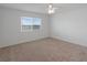 Carpeted bedroom features a ceiling fan and a window that faces the water at 3606 S Peninsula Dr # 707, Port Orange, FL 32127