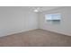 Bedroom with neutral carpeting, ceiling fan and a window with waterfront views at 3606 S Peninsula Dr # 707, Port Orange, FL 32127