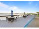 Dockside dining area with patio furniture, BBQ grills, and scenic waterfront views at 3606 S Peninsula Dr # 707, Port Orange, FL 32127