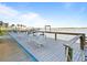 Waterfront dock with lounge seating, barbecue grills, and views of the water for outdoor entertaining at 3606 S Peninsula Dr # 707, Port Orange, FL 32127