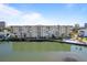 Beautiful waterfront condominium featuring a swimming pool and well-maintained landscaping at 3606 S Peninsula Dr # 707, Port Orange, FL 32127