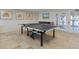 Well-lit game room with a ping pong table for fun and entertainment near exterior access doors at 3606 S Peninsula Dr # 707, Port Orange, FL 32127