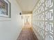Well-maintained hallway with brick flooring and unique architectural design at 3606 S Peninsula Dr # 707, Port Orange, FL 32127