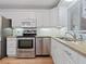 Bright kitchen features white cabinets, stainless steel appliances, and granite countertops at 3606 S Peninsula Dr # 707, Port Orange, FL 32127