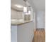 Kitchen area with white cabinets, stone countertops, and a view of the entryway at 3606 S Peninsula Dr # 707, Port Orange, FL 32127