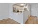 Open kitchen area with stainless steel appliances, white cabinets, and a breakfast bar at 3606 S Peninsula Dr # 707, Port Orange, FL 32127