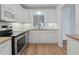 Bright kitchen featuring white cabinets, stainless steel appliances and granite countertops at 3606 S Peninsula Dr # 707, Port Orange, FL 32127
