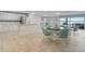Community kitchen features white cabinetry, granite countertops, stainless appliances, and dining area at 3606 S Peninsula Dr # 707, Port Orange, FL 32127