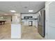 Spacious community kitchen featuring white cabinetry, stainless steel appliances, and a convenient breakfast bar at 3606 S Peninsula Dr # 707, Port Orange, FL 32127