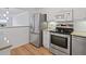 Modern kitchen featuring stainless steel appliances, granite countertops and hardwood floors at 3606 S Peninsula Dr # 707, Port Orange, FL 32127