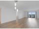 Open living room with wood flooring and sliding glass doors to a balcony at 3606 S Peninsula Dr # 707, Port Orange, FL 32127