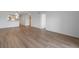 Spacious living room with wood flooring, white walls, and entryway at 3606 S Peninsula Dr # 707, Port Orange, FL 32127
