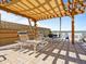 Patio area with modern pergola, lounge chairs and open views of the water at 3606 S Peninsula Dr # 707, Port Orange, FL 32127