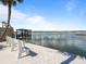 Scenic waterfront with dock and boat access, featuring seating along the bay at 3606 S Peninsula Dr # 707, Port Orange, FL 32127
