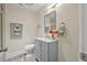Well-lit bathroom featuring gray vanity with drawers, fresh flowers, and decorative towels at 3889 Biscayne Dr, Winter Springs, FL 32708