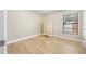 Bedroom featuring wood-look floors, white trim, and wardrobe with full mirror at 3889 Biscayne Dr, Winter Springs, FL 32708