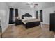 Spacious main bedroom with wood floors, black furniture, and a ceiling fan at 3889 Biscayne Dr, Winter Springs, FL 32708