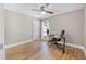 Bedroom featuring wood-look floors, ceiling fan, and desk with chair at 3889 Biscayne Dr, Winter Springs, FL 32708