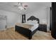 This spacious main bedroom includes a ceiling fan, wood floors, and modern furniture at 3889 Biscayne Dr, Winter Springs, FL 32708