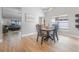 Dining area featuring wood floors, a modern chandelier, and natural light at 3889 Biscayne Dr, Winter Springs, FL 32708