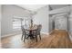 Dining area featuring wood floors, a modern chandelier, and natural light at 3889 Biscayne Dr, Winter Springs, FL 32708
