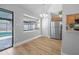 Bright kitchen features stainless steel appliances, wood floors, and a window overlooking the pool area at 3889 Biscayne Dr, Winter Springs, FL 32708