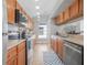 Bright kitchen features stainless steel appliances, wooden cabinetry, and tile backsplash at 3889 Biscayne Dr, Winter Springs, FL 32708