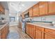 Bright kitchen features stainless steel appliances, wooden cabinetry, and tile backsplash at 3889 Biscayne Dr, Winter Springs, FL 32708